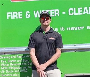 SERVPRO employee in front of green background