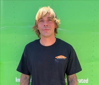 SERVPRO employee in front of green background
