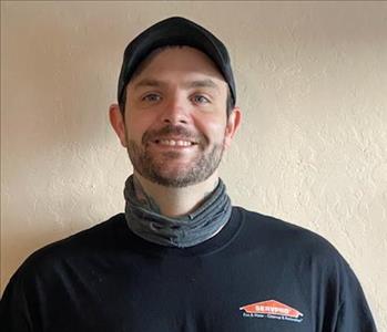 SERVPRO employee in front of off white background
