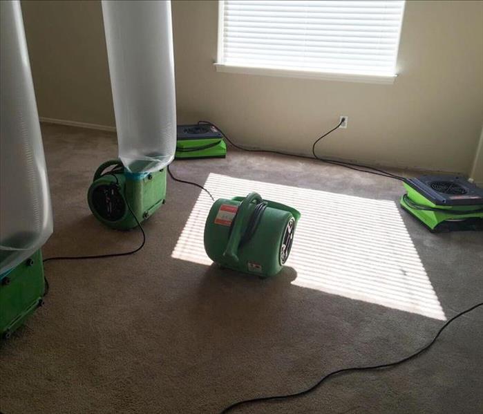 Drying equipment on carpet in the living room of a Prescott Valley home
