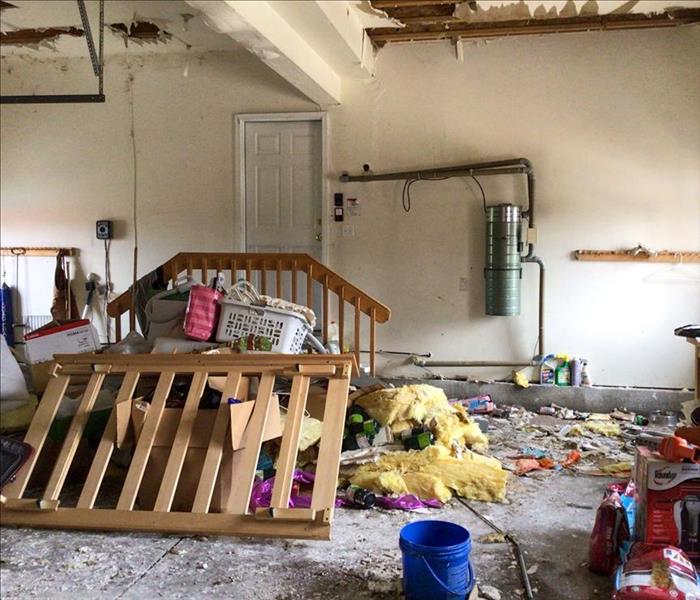 Damage in a garage in Prescott Valley, AZ due to heavy rains and a ceiling leak.