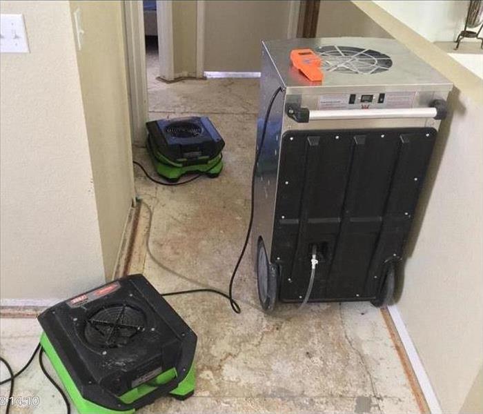 Restoration machines are cleaning a house that suffered water damage.