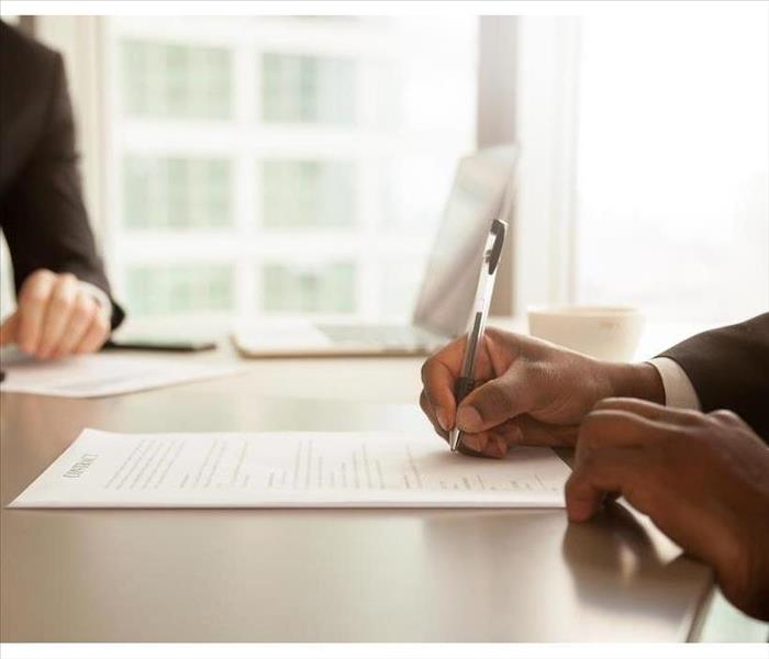 Afro american businessman signing partnership agreement concept.