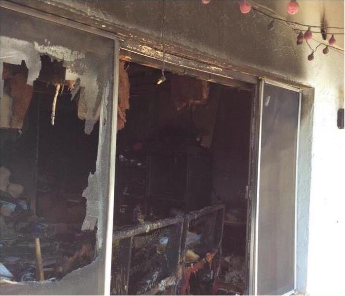 Broken windows in a home, fire damage in a home